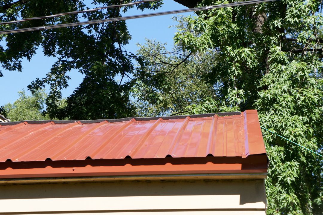 New roof being expertly installed in Cannonvale, incorporating gutter systems for optimal water drainage and maintenance, with specialized attention to waterproofing and storm damage prevention