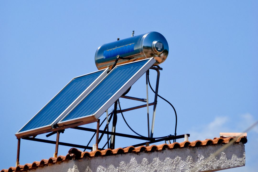 Solar hot water system efficiently mounted on a residential roof in Airlie Beach, showcasing advanced energy-efficient technology and water heating solutions suitable for local climate conditions